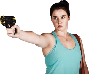 A woman pointing a gun at a gray background in her home.