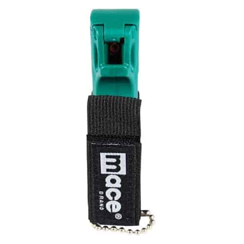 A green and black Mace® Canine Repellent key ring with the word moce, which could be mistaken for "mace," on it.