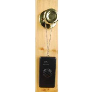 A black doorbell hanging on a wooden door that doubles as a 2n1 Personal & Burglar Alarm.