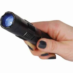 A person gripping a BashLite 85,000,000 volt Stun Gun Flashlight emitting a blue light.