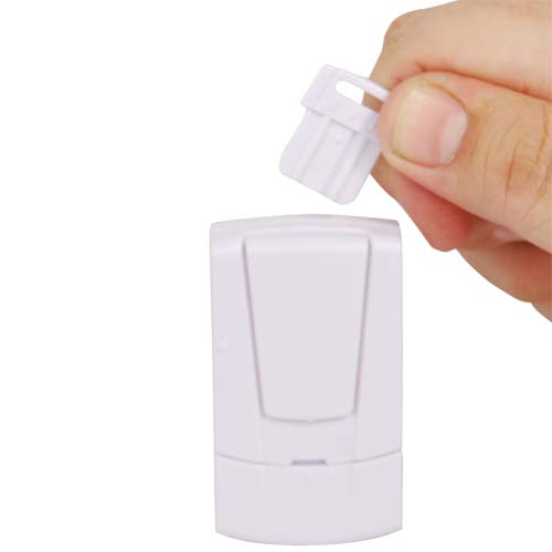 A person is holding a small white Magnetic Door Alarm with Disarm Key device.