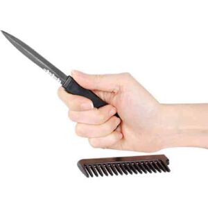 A hand holding a Comb Metal Knife.