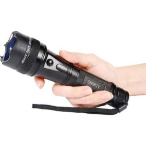 A person ensuring safety with a Safety Technology Shorty Flashlight Stun Gun 75,000,000 volts in their hand.