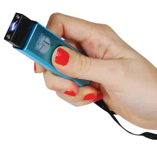 A woman's hand holding a Slider Stun Gun LED Flashlight USB Recharger.