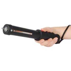 A person's hand holding a black electric Safety Technology Repeller Stun Baton.