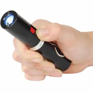 A person holding a Lipstick Stun Gun Rechargeable With Flashlight.