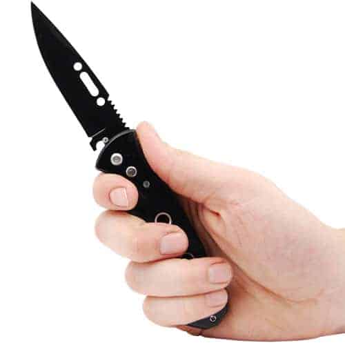 An Automatic Heavy Duty Knife with solid handle held firmly in a person's hand.