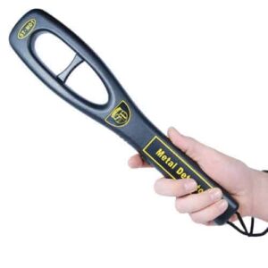 A person's hand holding a black and yellow Safety Technology Hand Held Metal Detector, emphasizing safety technology.