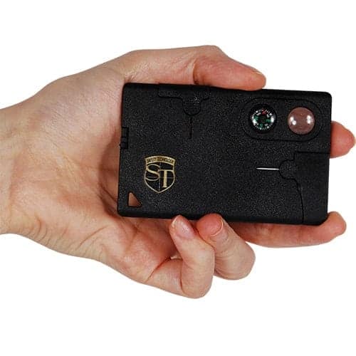 A person holding a small black Multi Function Combination Tool Card with a logo on it.