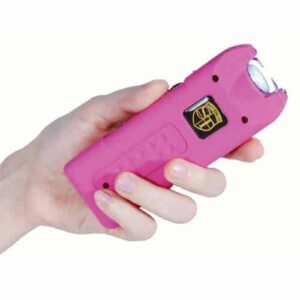 A hand holding a MultiGuard Stun Gun Rechargeable With Alarm and Flashlight.