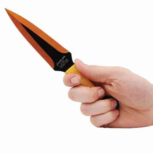 A person's hand holding a 2 Piece Throwing Knife Black/Gold Color BioHazard on a white background.