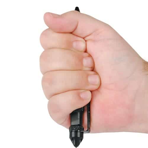 A Tactical Black Twist Pen with Extra Refill held by a man's hand on a white background.