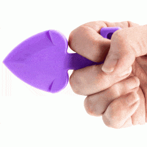 A person holding a purple spatula in their hand, with a Heart Attack Key Chain.