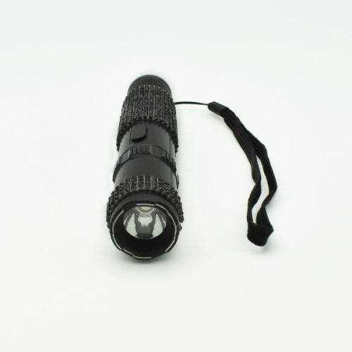 A small black RhineStun 75,000,000* Stun Flashlight featuring textured grips and a wrist strap is placed on a white surface.