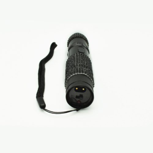 A sleek black RhineStun 75,000,000* Stun Flashlight with a textured grip and attached wrist strap rests elegantly on a plain white surface.