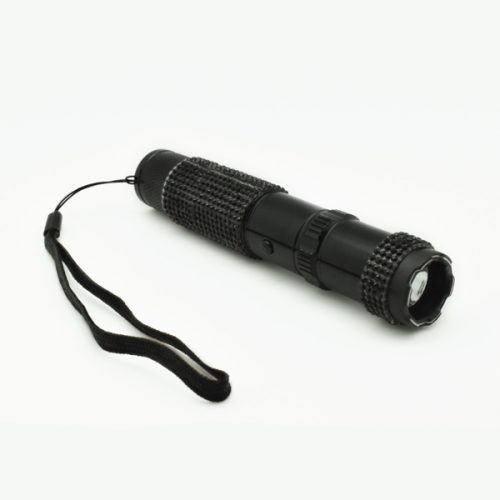 A black RhineStun 75,000,000* Stun Flashlight with a textured grip and wrist strap rests elegantly on a light surface.