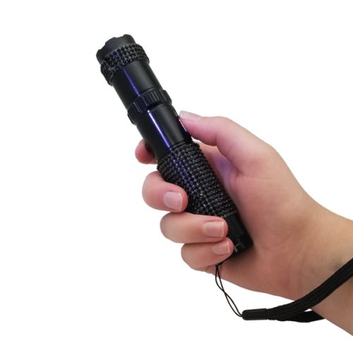 Grasp the textured handle of the black RhineStun 75,000,000* Stun Flashlight, featuring a secure wrist strap. Its powerful illumination makes it perfect for lighting your path or serving as an emergency stun flashlight.