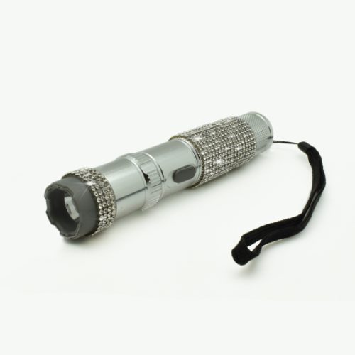 Meet the RhineStun 75,000,000* Stun Flashlight: a fusion of elegance and power with its silver design, textured grip adorned with rhinestones, and convenient wrist strap.