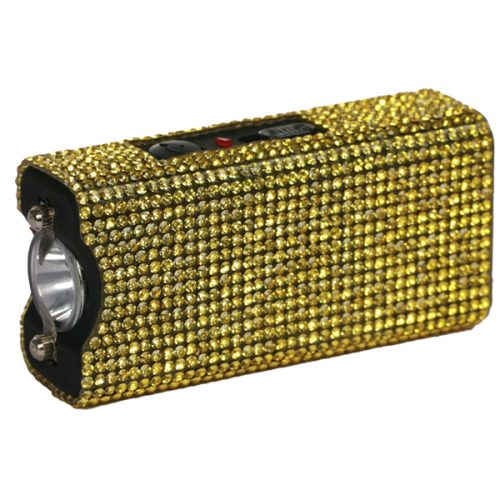 The Rhinestun Keychain Stun Gun boasts a gold rhinestone cover with a sleek black edge, a lens on one end, and a top switch, making it both chic and practical for any keychain.