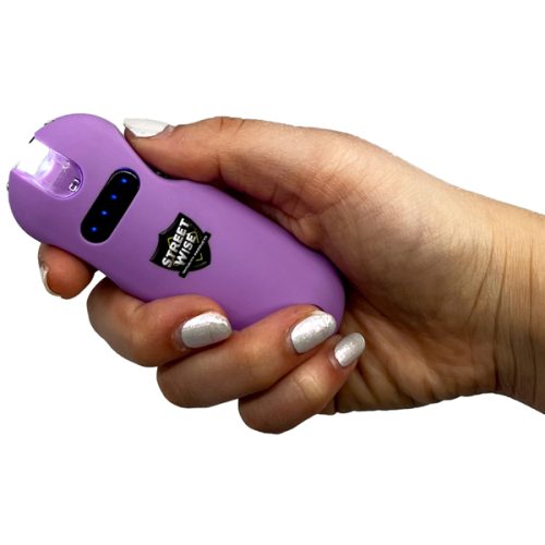 A person clutches a "SMART 24,000,000" Keychain Stun Gun in purple for safety.