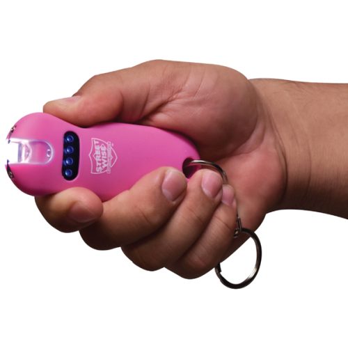 A hand holds the SMART 24,000,000* Keychain Stun Gun, a sleek pink device designed for convenience and quick access.