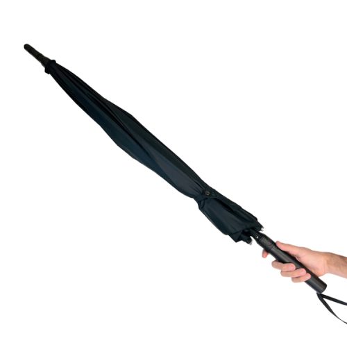 A hand grasps the closed Tactical Stunbrella with a straight handle, set against a plain white background.